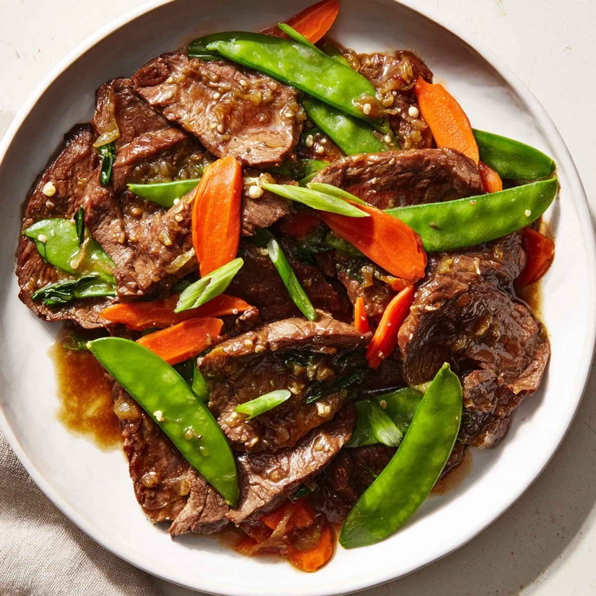 Vibrant Beef Stir Fry with Snow Peas and Carrots features juicy beef strips, crunchy vegetables, and a flavorful glaze perfect for family-style Asian-inspired dinners.