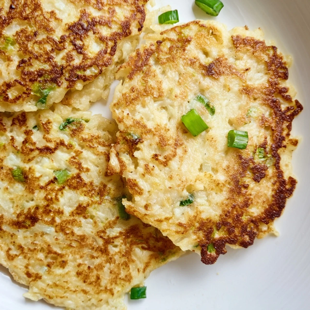 Rustic Irish Boxty Potato Pancakes featuring fluffy centers, crispy edges, and fresh scallions on a plate.