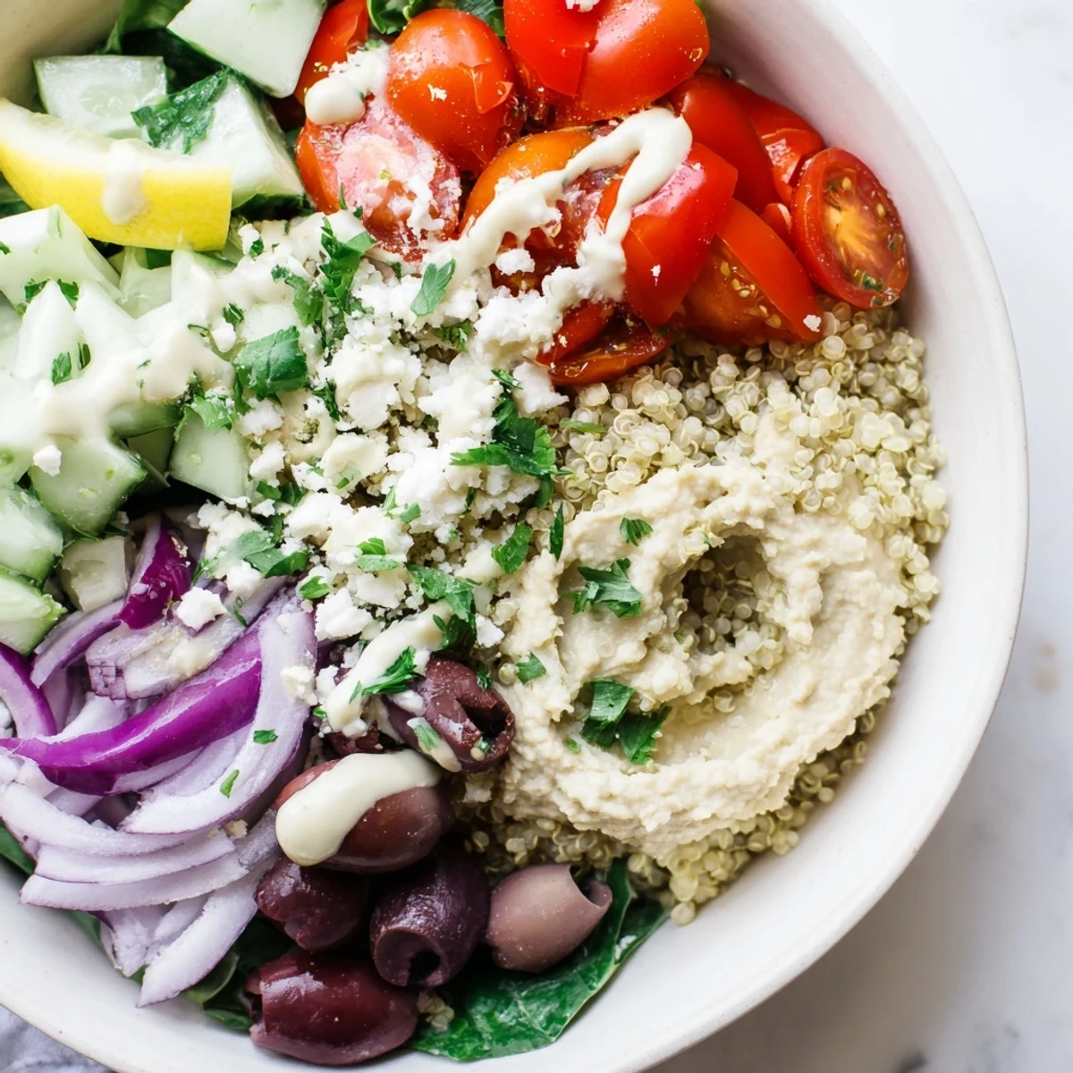 Freshly prepared Mediterranean Quinoa Bowl featuring Kalamata olives, roasted red peppers, and crumbled feta cheese for a savory finish.