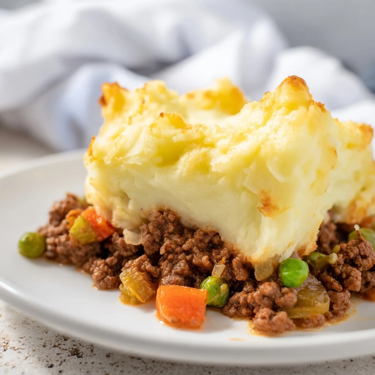 Forklift-ready Beef Shepherds Pie with Cheddar Mash features golden, bubbling cheese crust over savory beef and vegetable filling.
