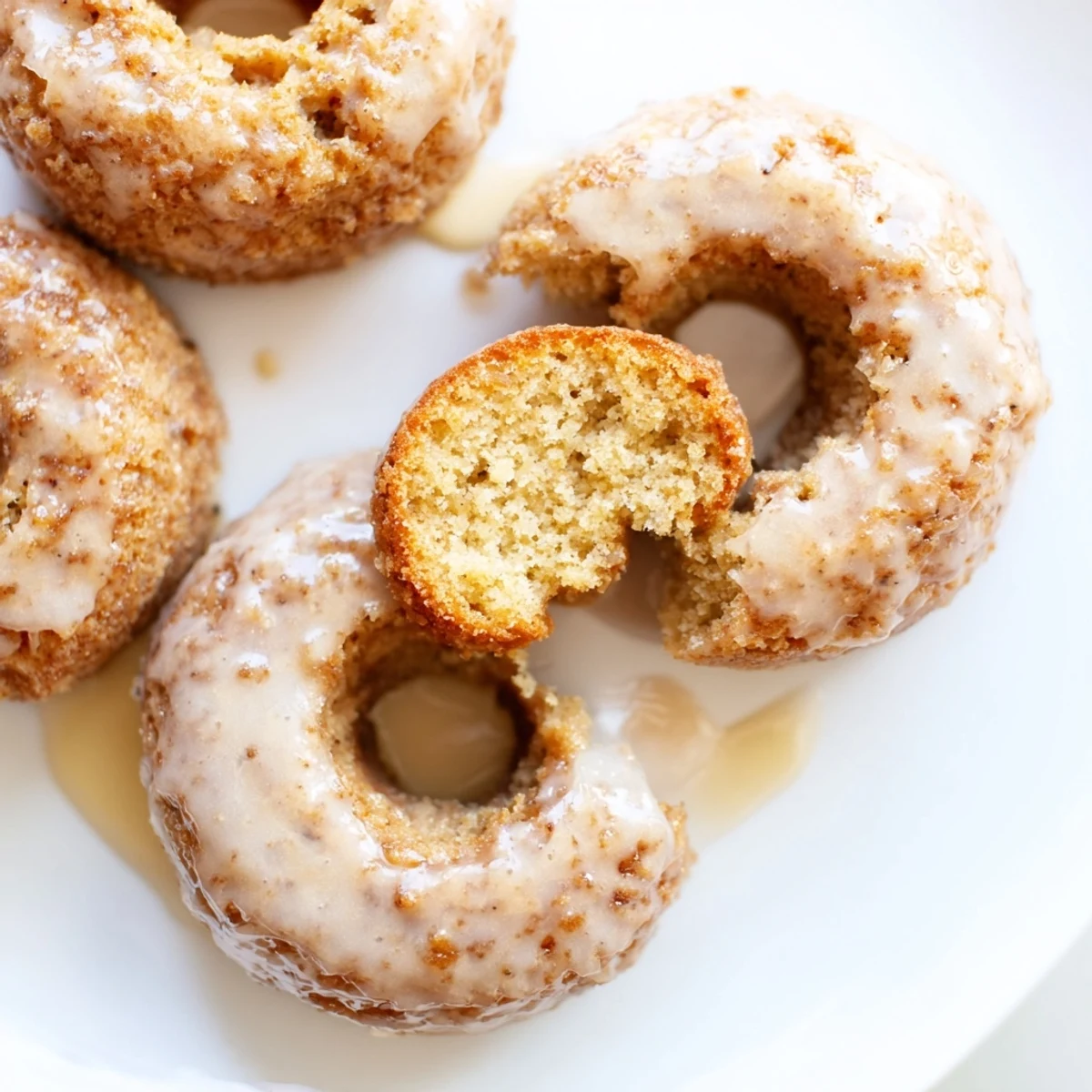 Freshly baked Baked Banana Bread Donuts with tender crumb, perfect for breakfast or sweet snack on a wooden board.