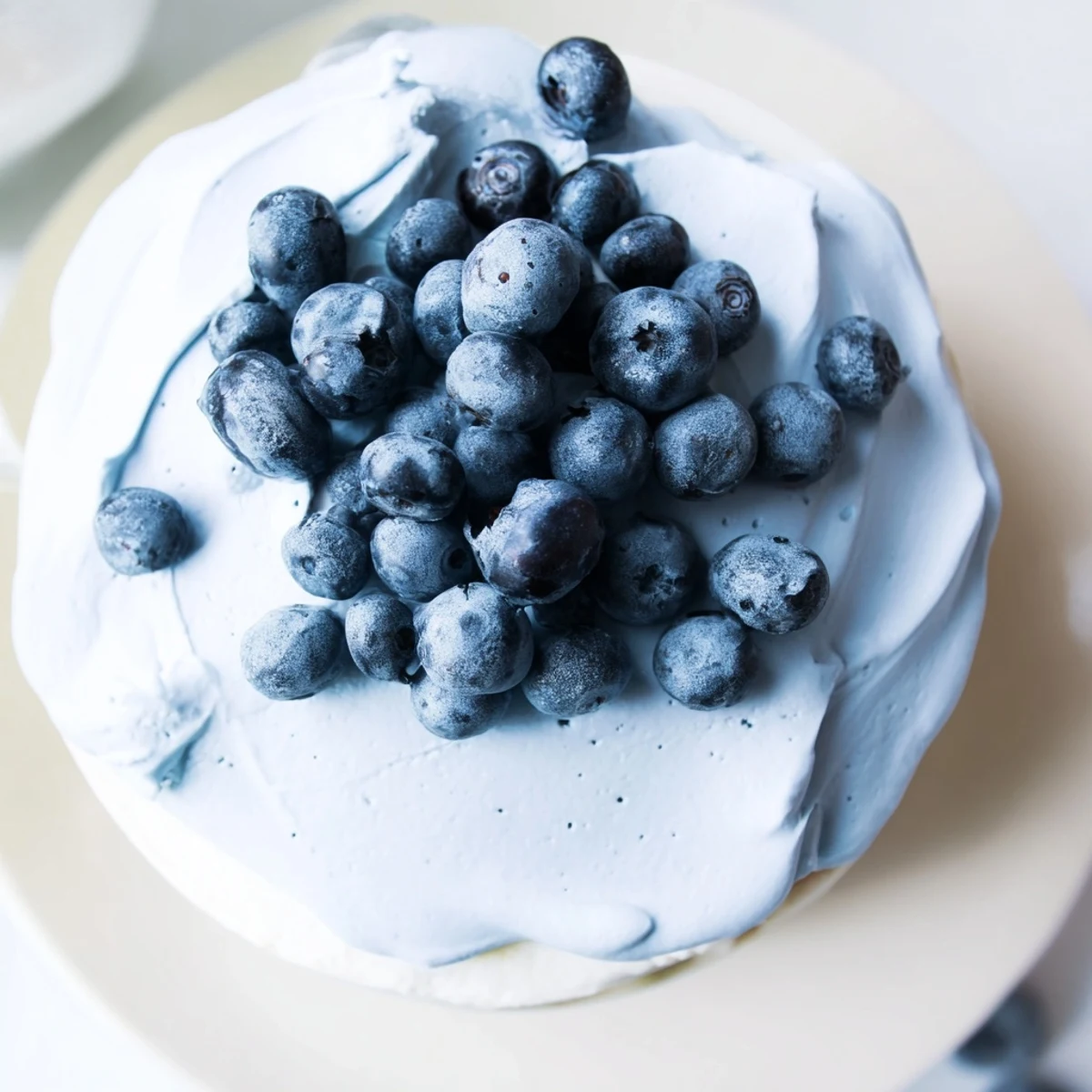 Close-up view of Blueberry Mousse Cheesecake, revealing a graham cracker crust and a rich, creamy texture perfect for special gatherings.