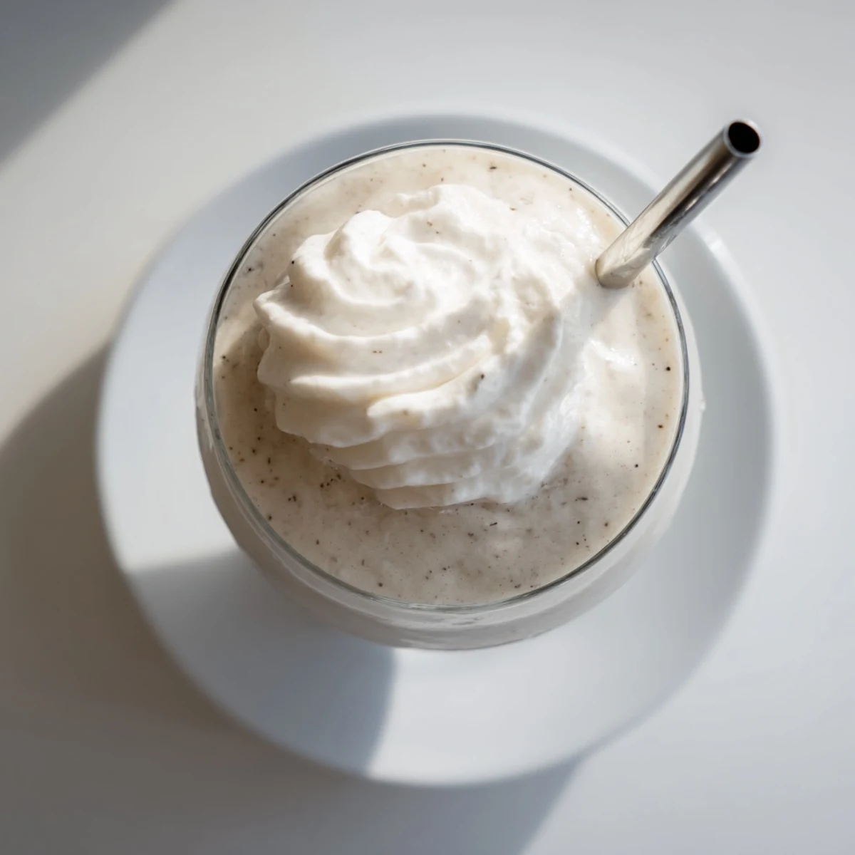 Cold Vanilla Bean Frappuccino served with a straw in a frosty glass, perfect for sweet summer sipping.