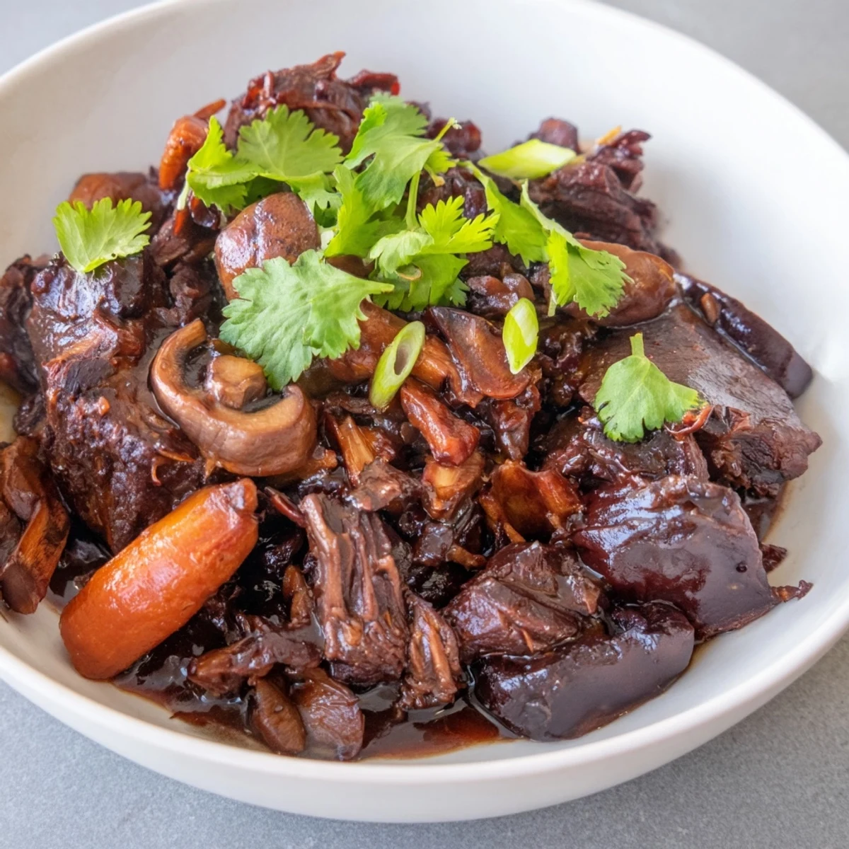 Tender Asian Style Slow Cooked Beef Cheeks with Mushrooms in a glossy, umami-rich sauce served over steamed rice.