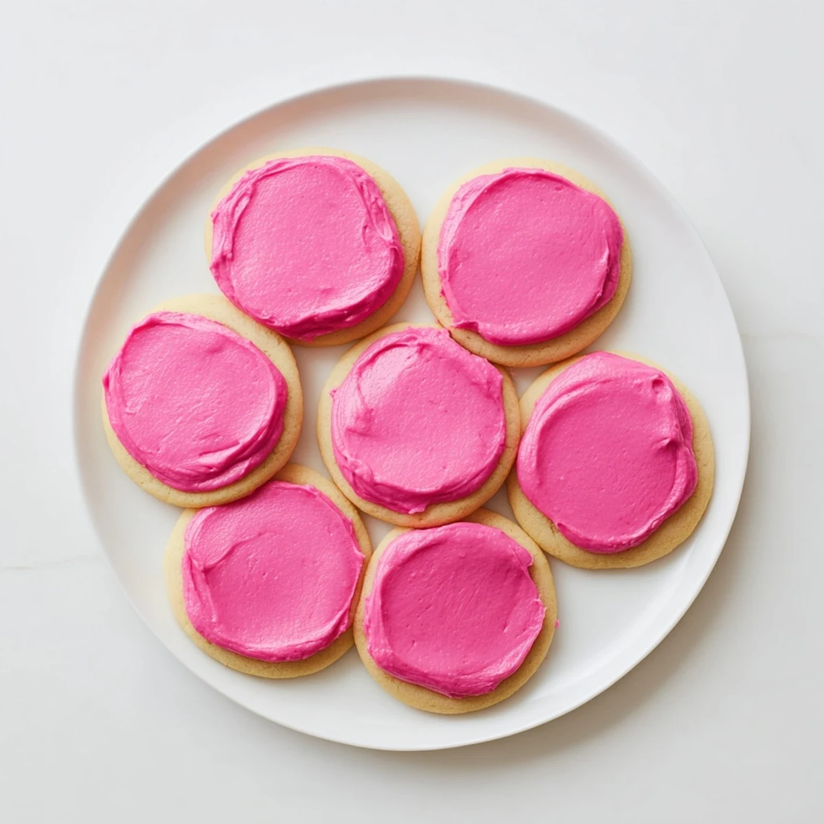 Close-up of Crumbl Pink Sugar Cookies showing soft texture and vibrant pink frosting.