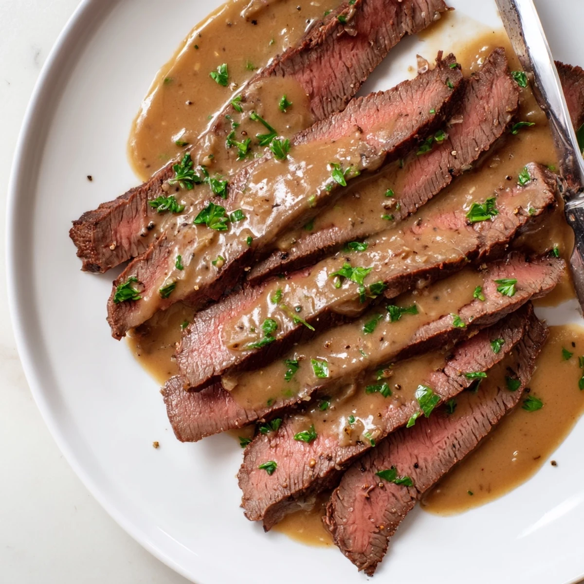 Flank steak with roasted garlic sauce and roasted potatoes for a special American dinner.