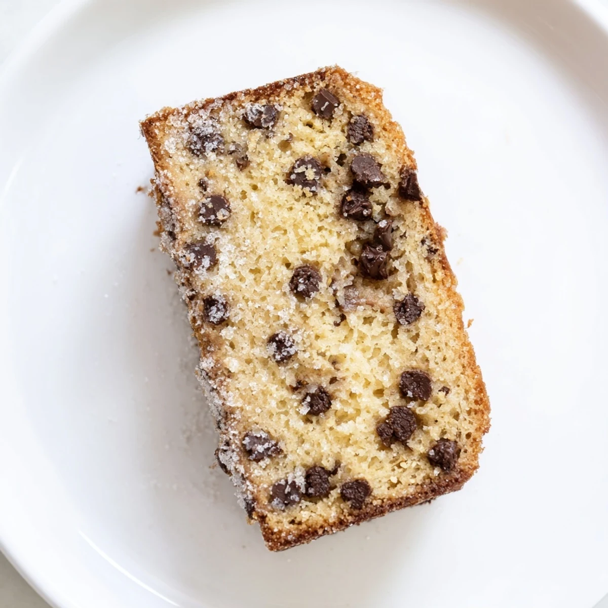 This Chocolate Chip Cake shows golden crumbs and a scoop of vanilla ice cream.