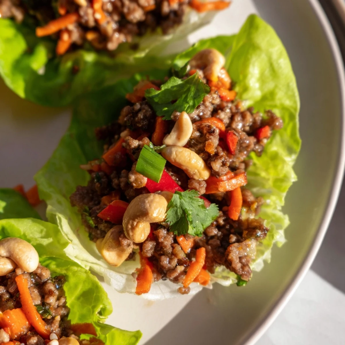 Crisp butter lettuce cups filled with savory seasoned ground beef, crunchy chopped cashews, and fresh garnishes