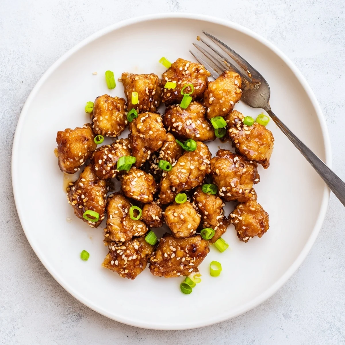 Weeknight dinner plate featuring juicy honey garlic chicken served over steamed rice with glossy coating
