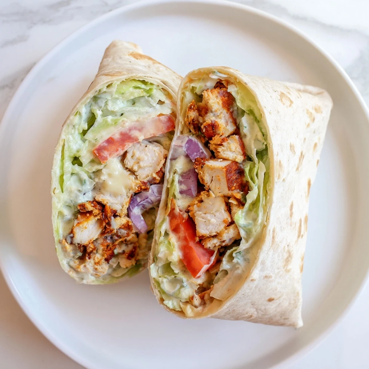 Soft flour tortilla rolled around juicy seasoned chicken strips with melted shredded cheese and fresh colorful vegetables