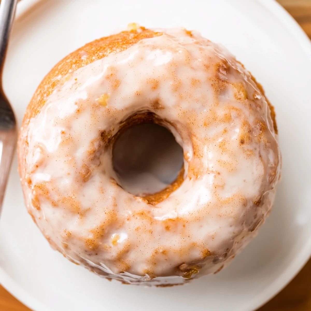 Warm Banana Donuts glazed and stacked on a wire rack, steaming.