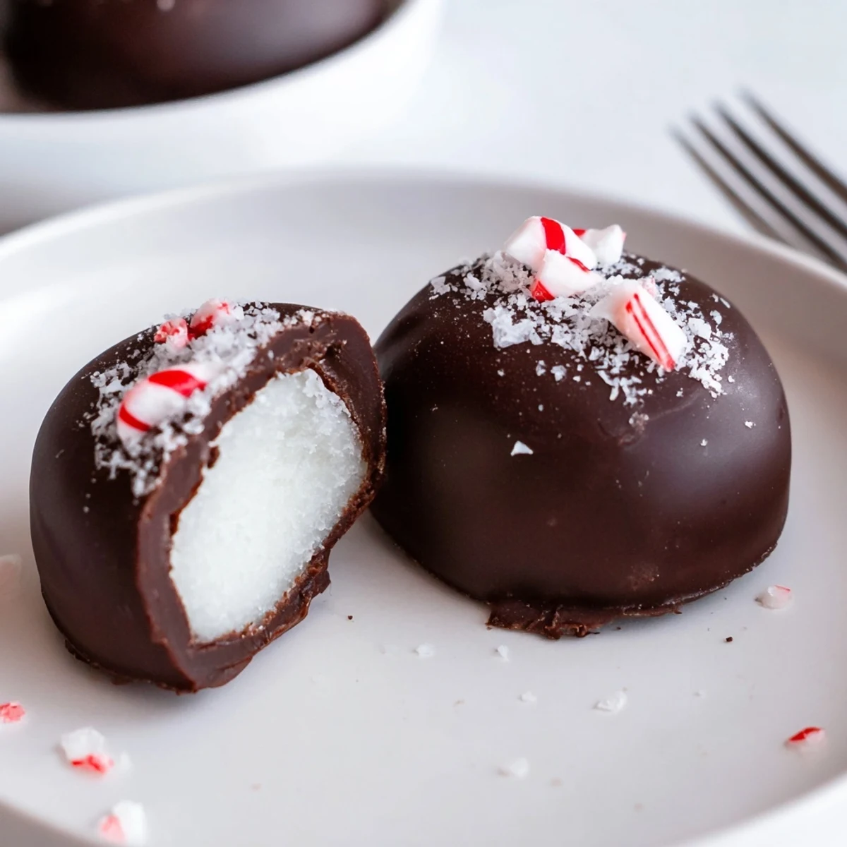 Cross-section shows creamy white center of Peppermint Patties beside coffee cup.