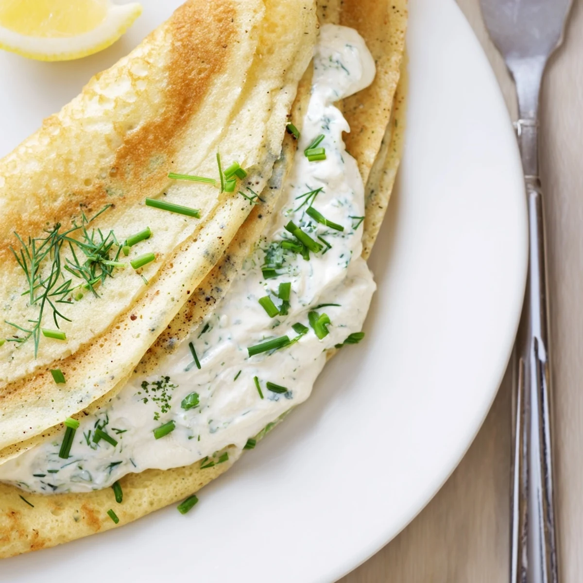 Smoked Salmon Crepes Recipe: thin golden crepes folded around silky salmon with lemon