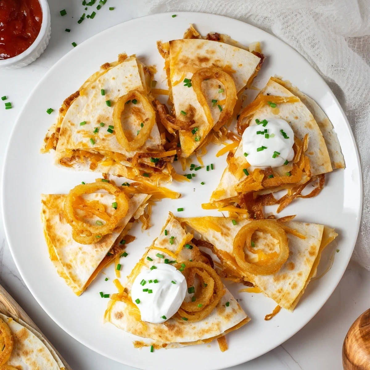 Golden crispy onion ring chips and melted cheddar cheese inside a folded flour tortilla