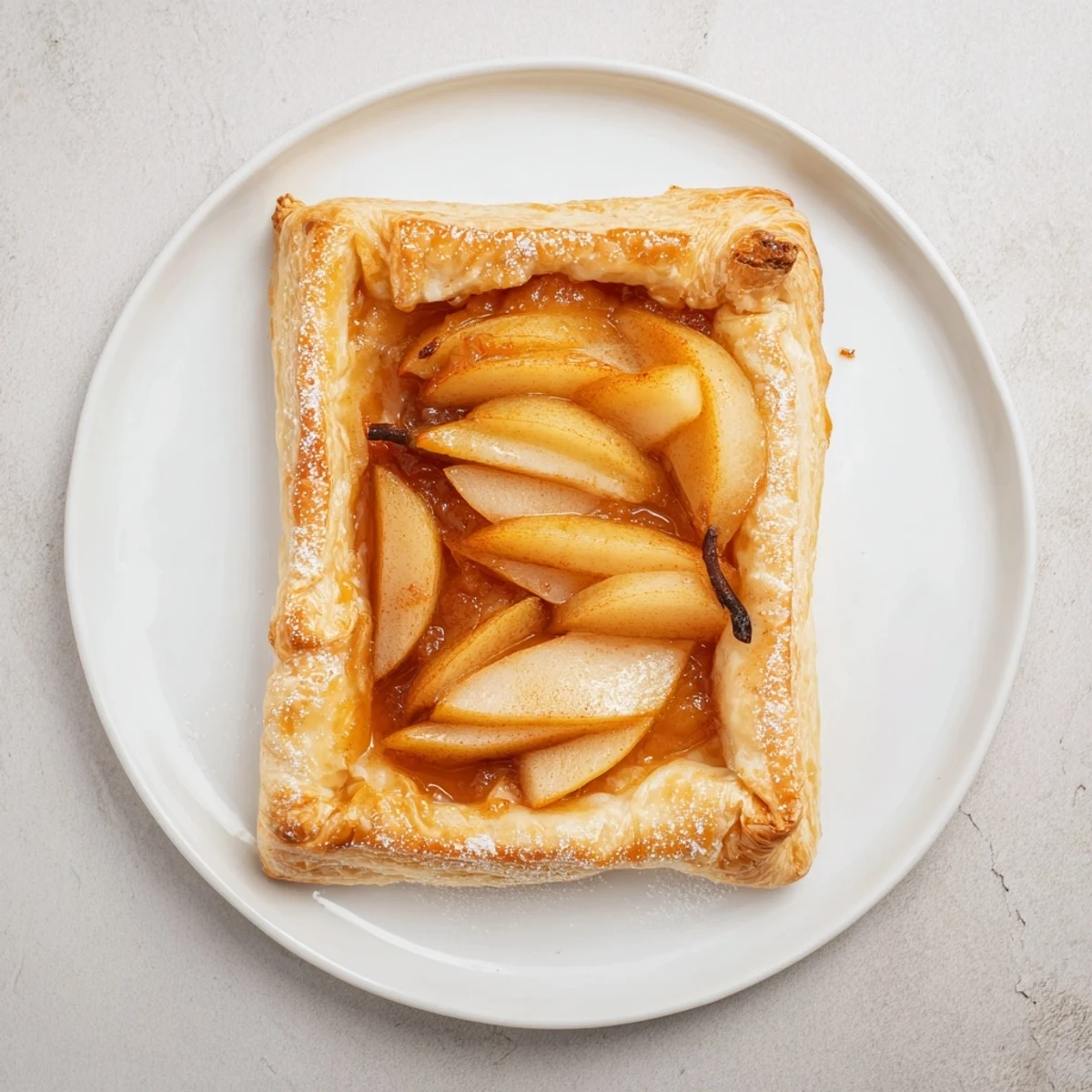 Velvety pear slices in Pear Puff Pastry Recipe served warm with vanilla ice cream