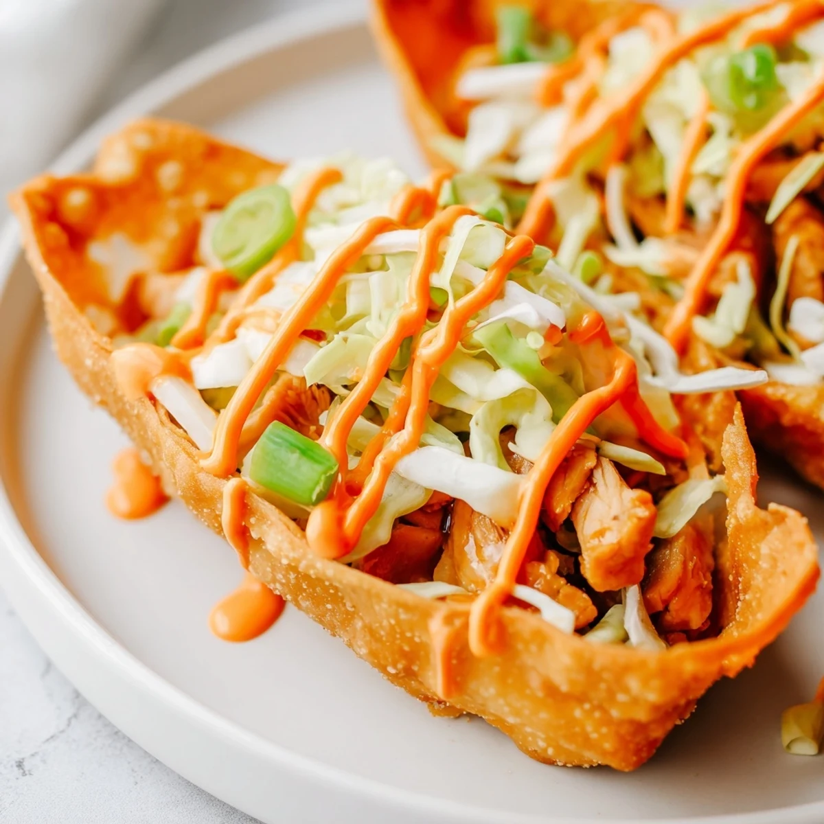Golden baked wonton shells filled with savory marinated chicken and fresh crunchy cabbage slaw