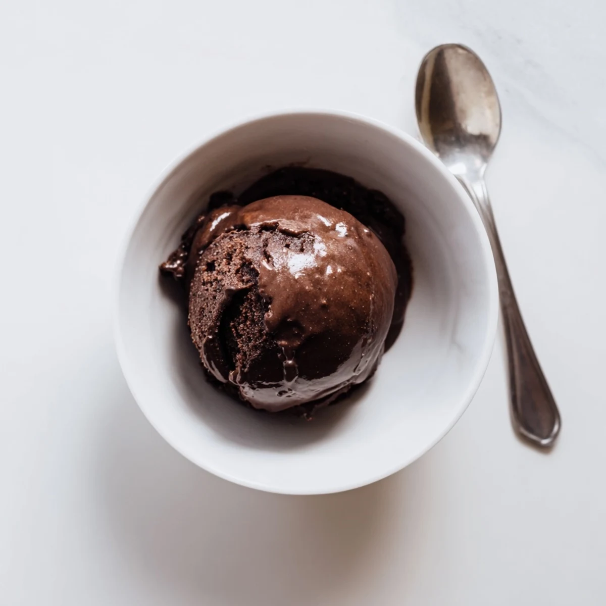 Velvety chocolate sourdough ice cream garnished with fresh raspberries and a sprinkle of sea salt
