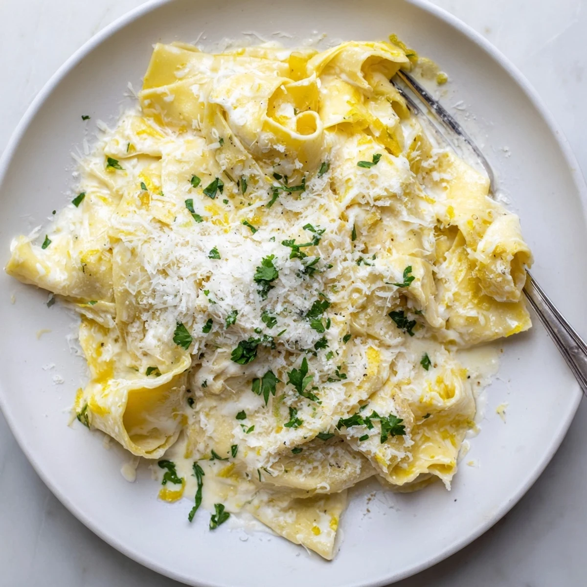 Creamy cafeteria noodles served steaming hot in a white bowl with grated cheese topping
