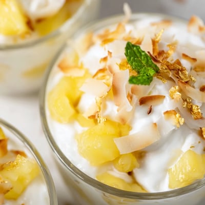 Creamy mini pineapple condensed coconut milk layered over juicy diced pineapple in individual glass bowls